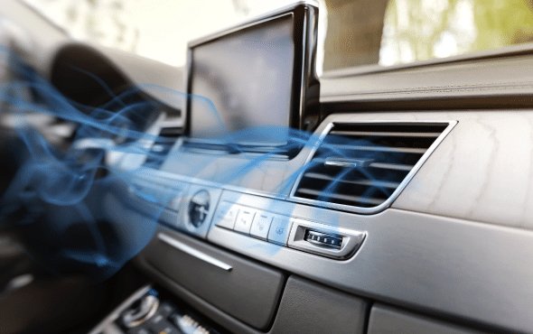 Car dashboard with air conditioning vents releasing cool air, visualized by blue motion lines, and a GPS screen visible.