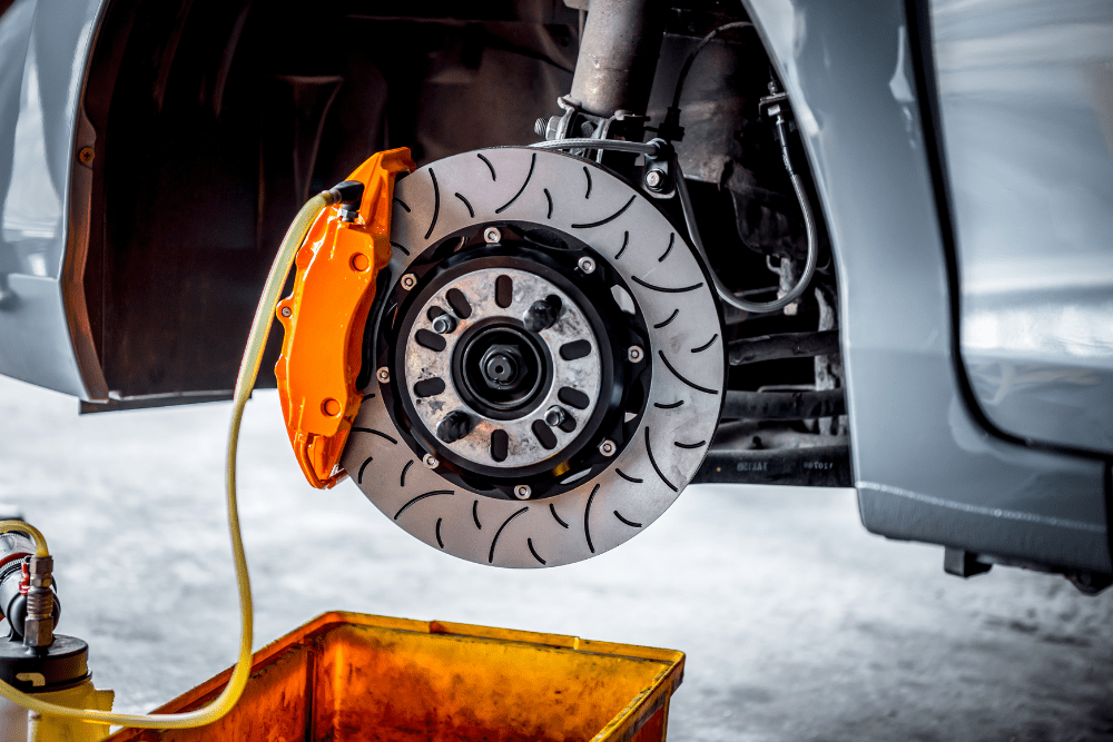 winter preventative maintenance, auto repair in Chicopee, MA at E & G Automotive. Image showcasing a vehicle's braking system being serviced with a snowy background.