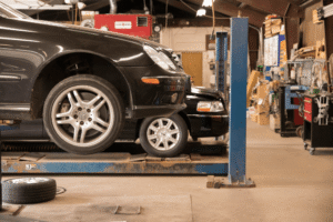 Car care, auto repair in Chicopee, MA, at E&G Automotive. Image of vehicles on service lifts inside a professional auto repair facility, highlighting expert diagnostics, maintenance, tire services, brake repairs, and complete automotive care for reliable vehicle performance.