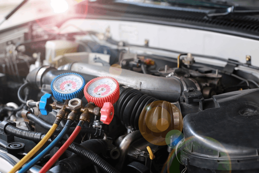 Auto a/c repair in Chicopee, MA, at E&G Automotive. A/C manifold gauges connected to a vehicle's air conditioning system during professional diagnostics, measuring refrigerant pressure to accurately identify leaks, performance issues, and determine whether the system needs repair or refrigerant recharge.